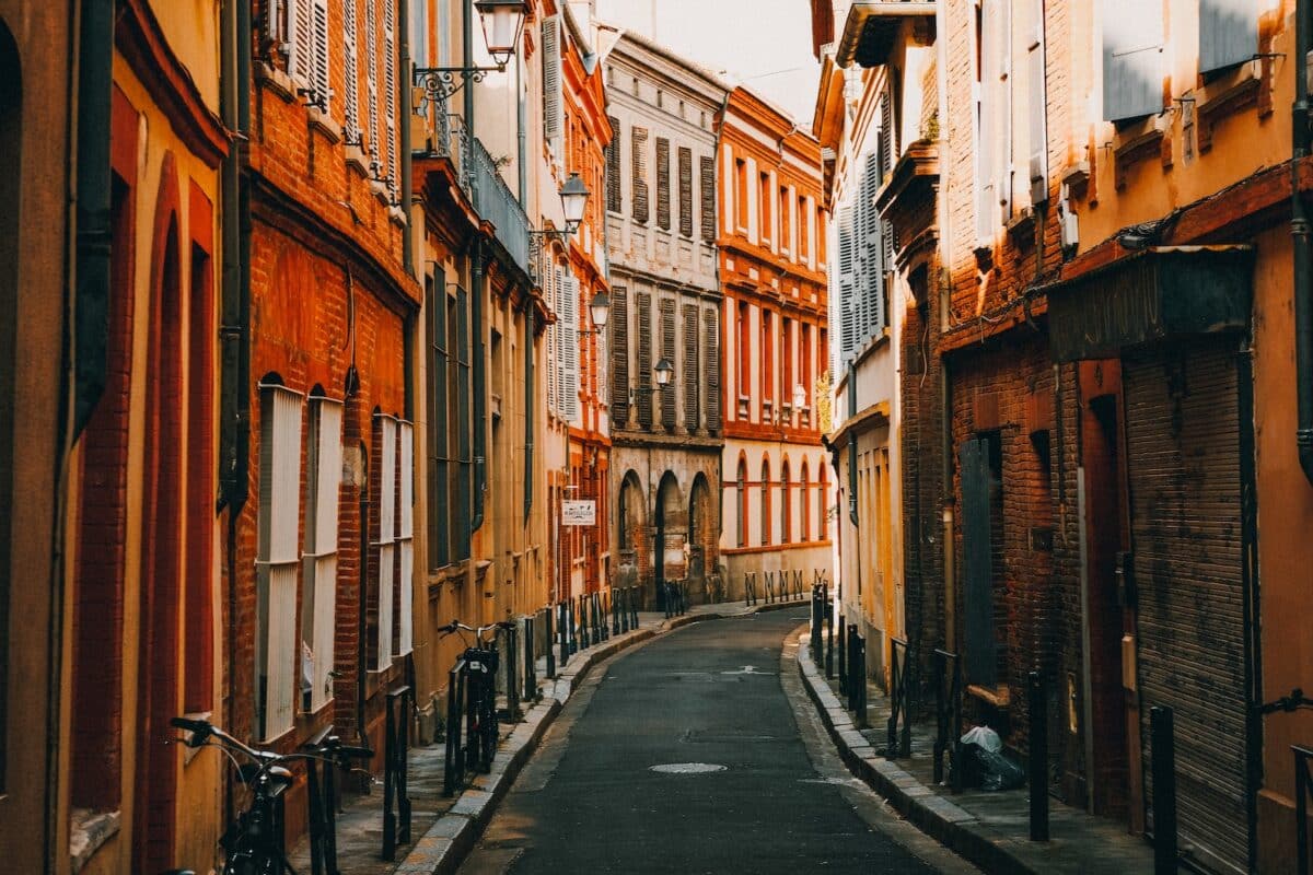 people walking on street between buildings during daytime